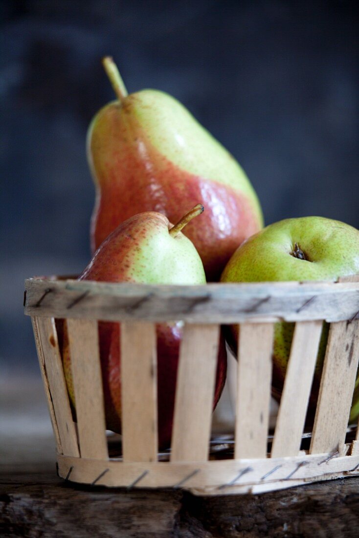 Three pears in a wooden basket