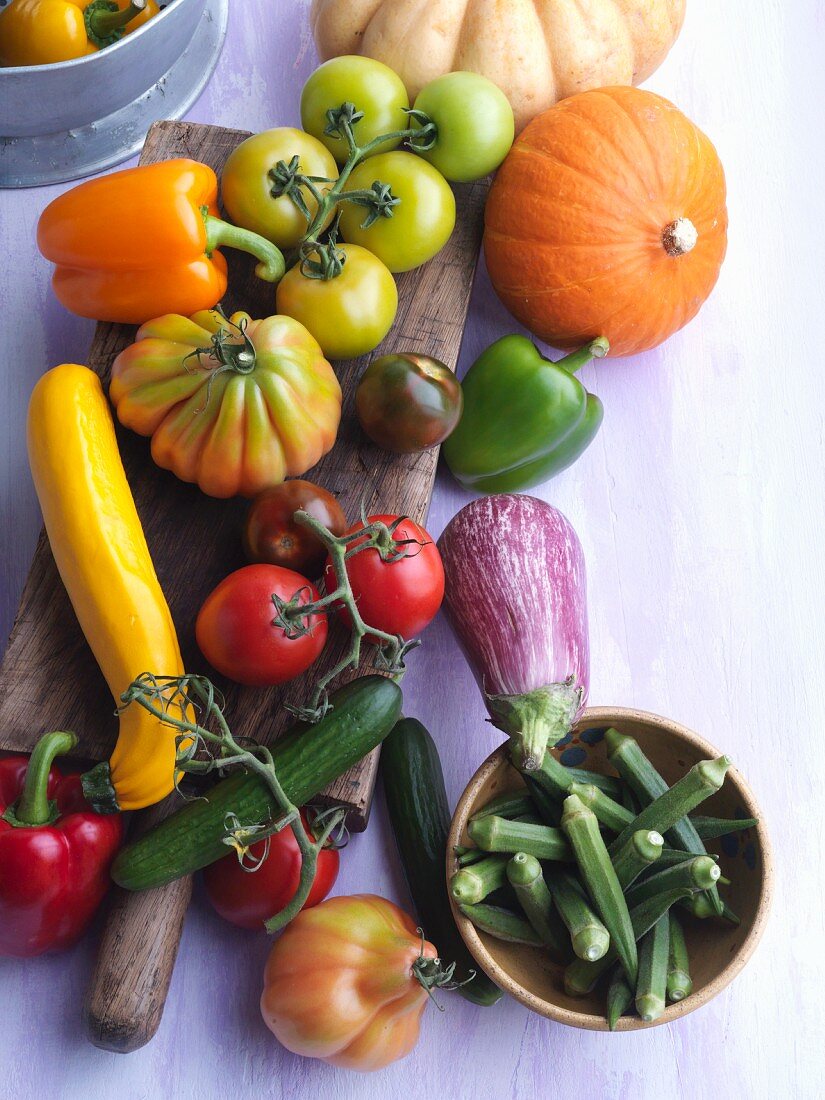 An arrangement of vegetables with tomatoes, courgettes, peppers and okra