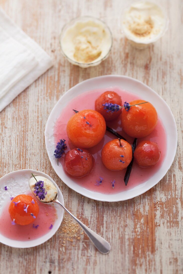 A plate of plum compote with lavender sprigs, seen from above