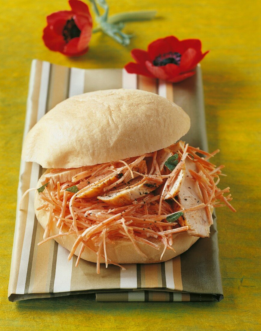 A pita bread filled with chicken and grated carrots