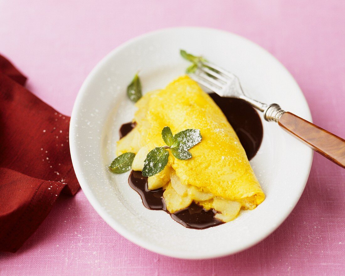 Pancakes with apple and chocolate sauce