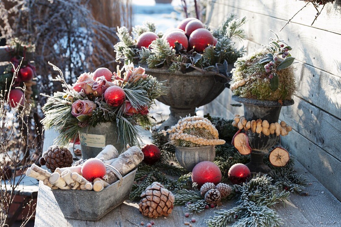 A Christmas terrace arrangements with frozen roses, twigs and pine