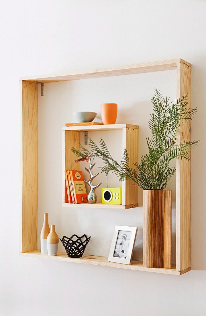 Different sized wooden frames as a pretty wall shelf