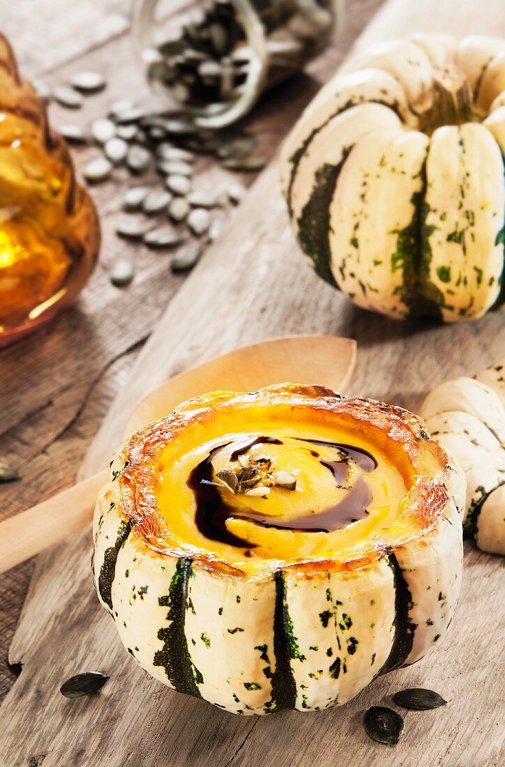 Pumpkin soup in a hollowed-out green and white pumpkin