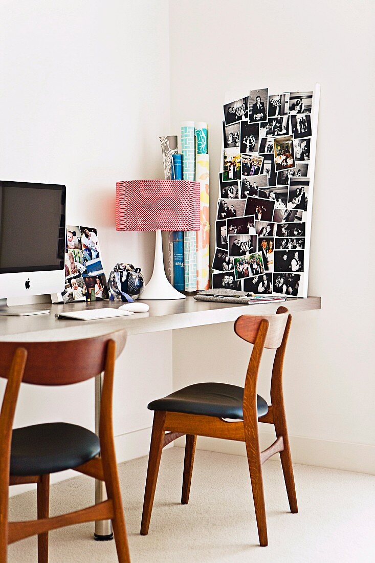 60s table lamp and photo collage on desk; retro chairs with leather seat cushions