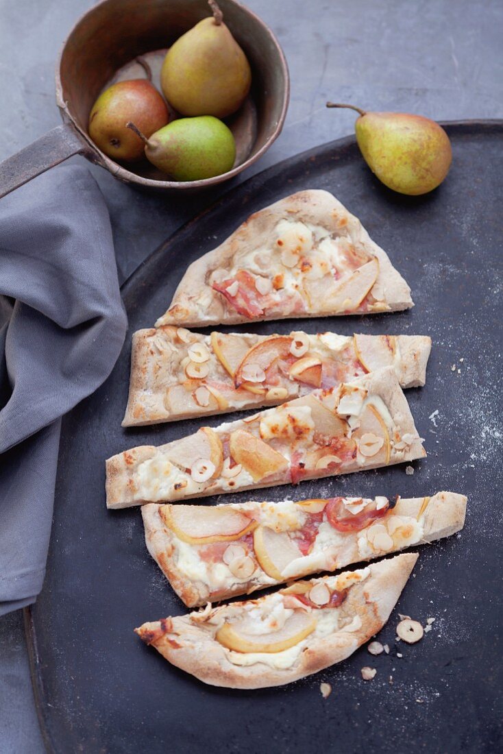 Tarte flambée topped with pears, sliced