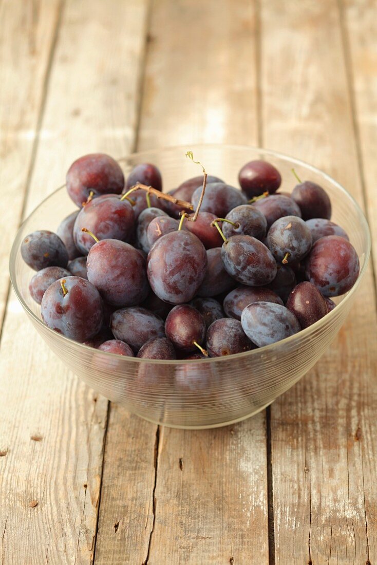 Plums in a glass bowl