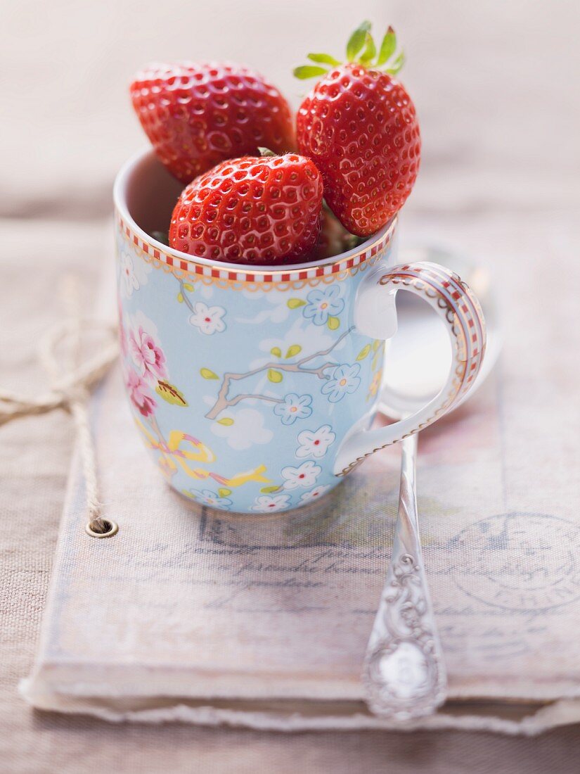 Strawberries in a floral-patterned cup