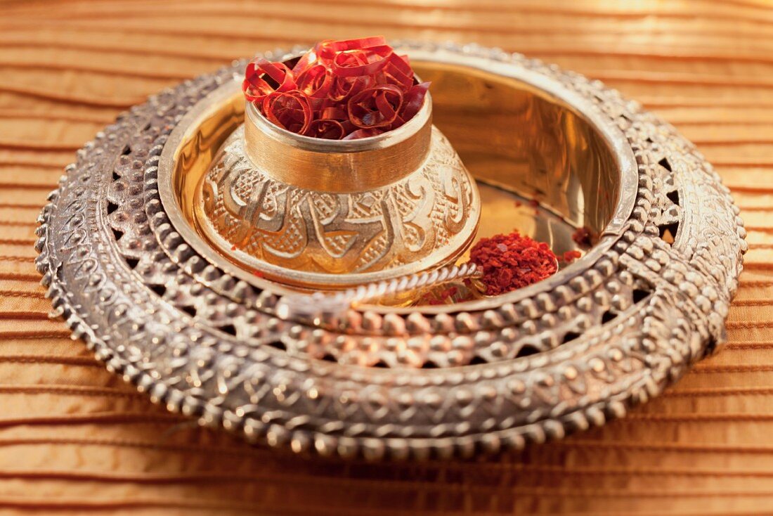 Dried chilli rings and chilli flakes in brass containers