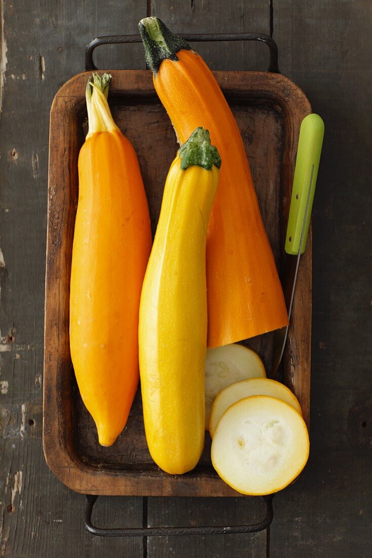 Yellow courgettes, partially sliced