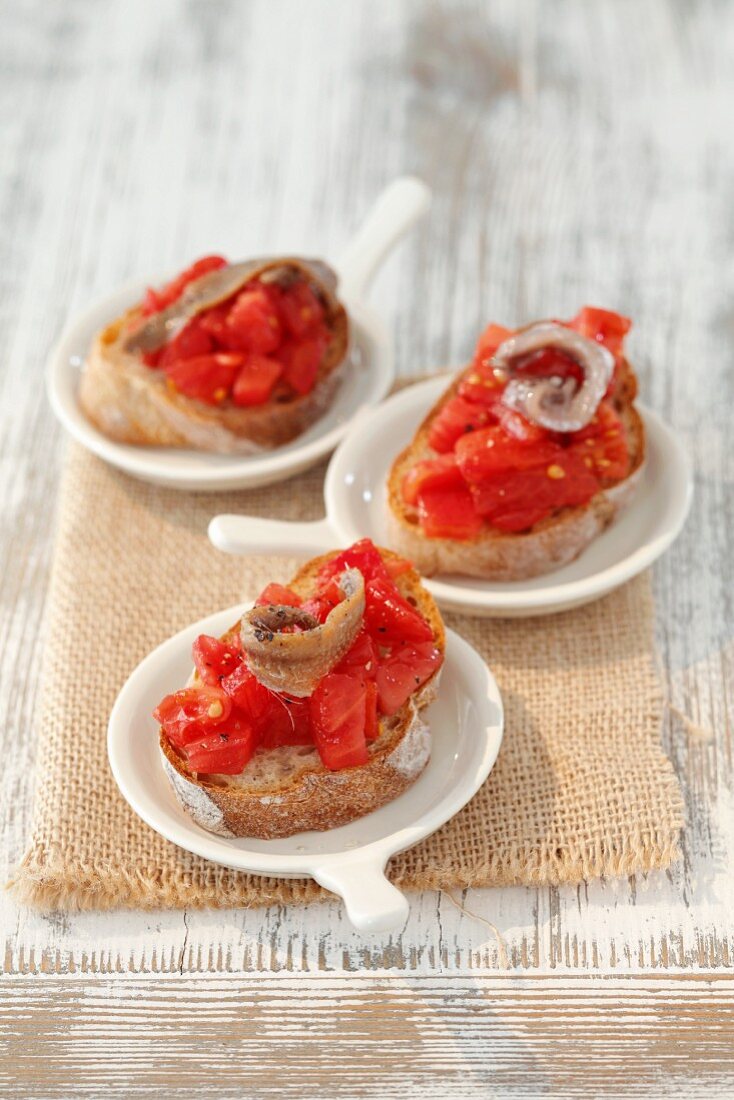 Bread topped with tomatoes and anchovies (tapas, Spain)