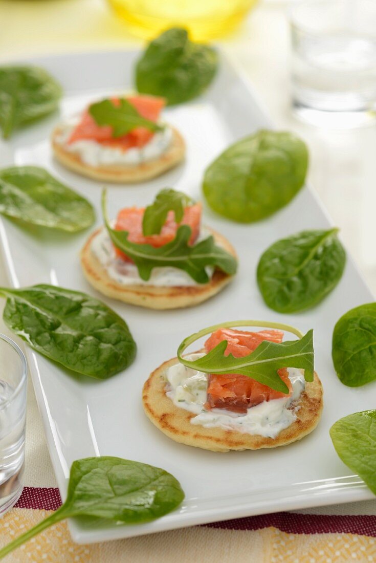 Mini pancakes topped with smoked salmon and cream cheese