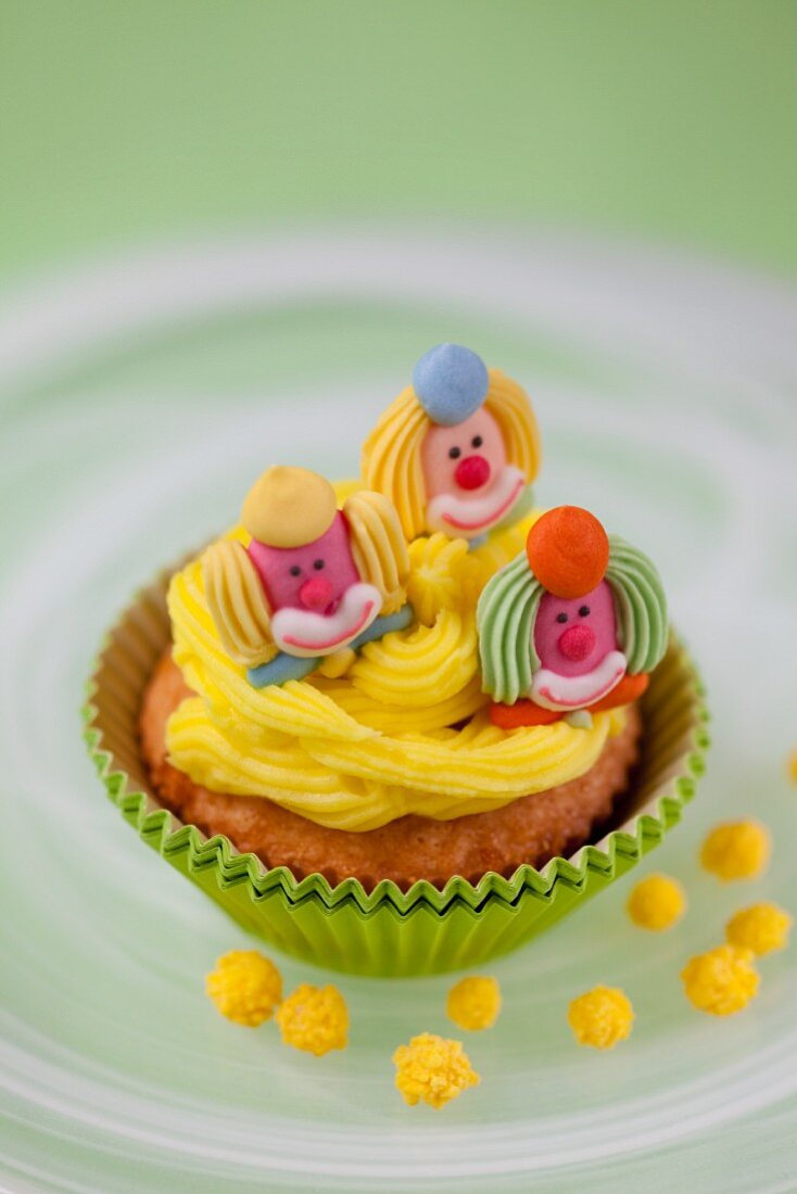 A cupcake decorated with marzipan pigs