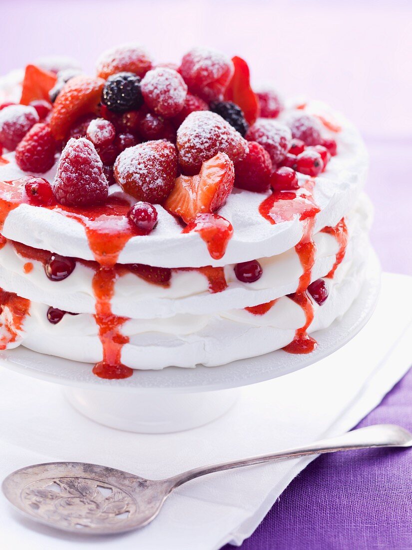 Pavlova with fresh berries on a cake stand