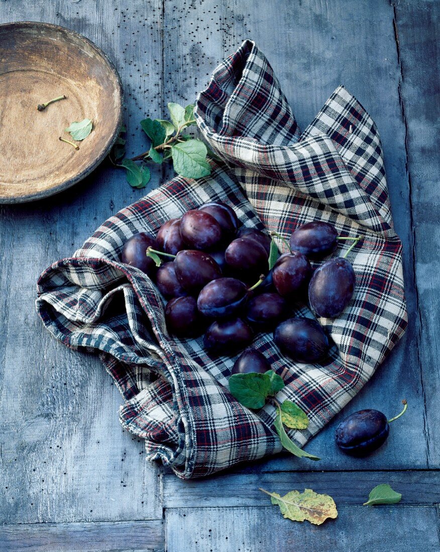 Fresh plums on a checked cloth