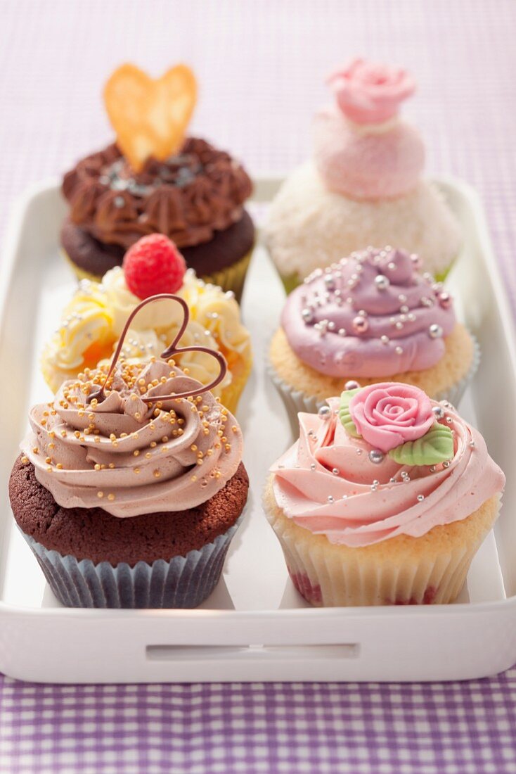 Various cupcakes decorated with sugar balls