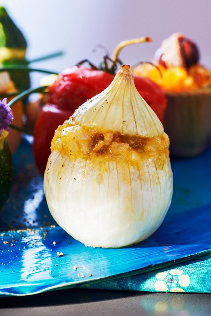 An onion filled with eggs, toast, grated Emmental and basil