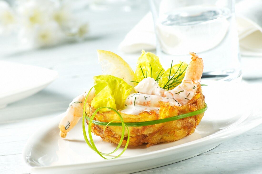 Prawns in a dill and yoghurt sauce with lettuce leaves in a potato nest