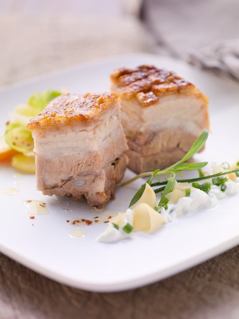 Crispy roast pork with garlic cream and a radish medley