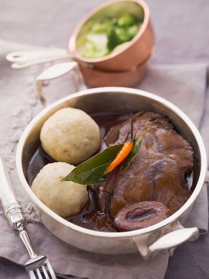 Beef pot roast with dumplings and sour damsons