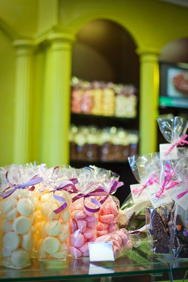 Packets of sweets on a glass counter