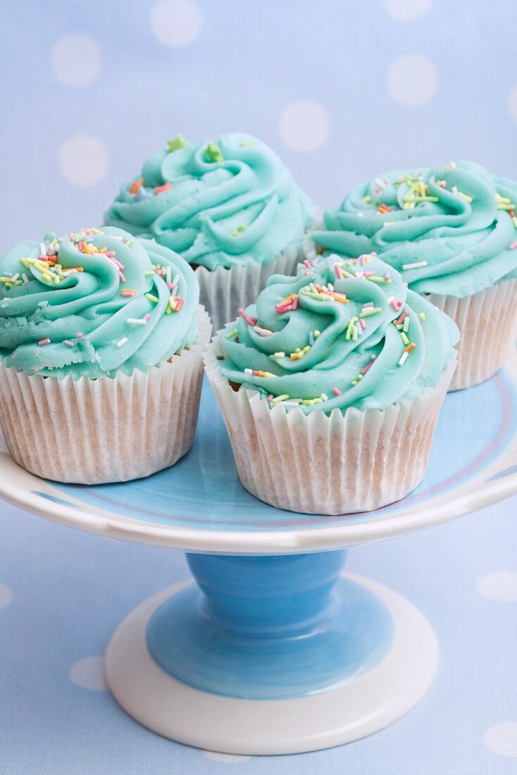 Cupcakes with turquoise frosting a sugar sprinkles