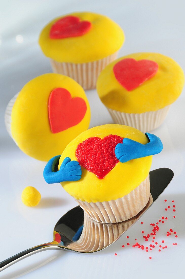 Yellow cupcakes decorated with hearts
