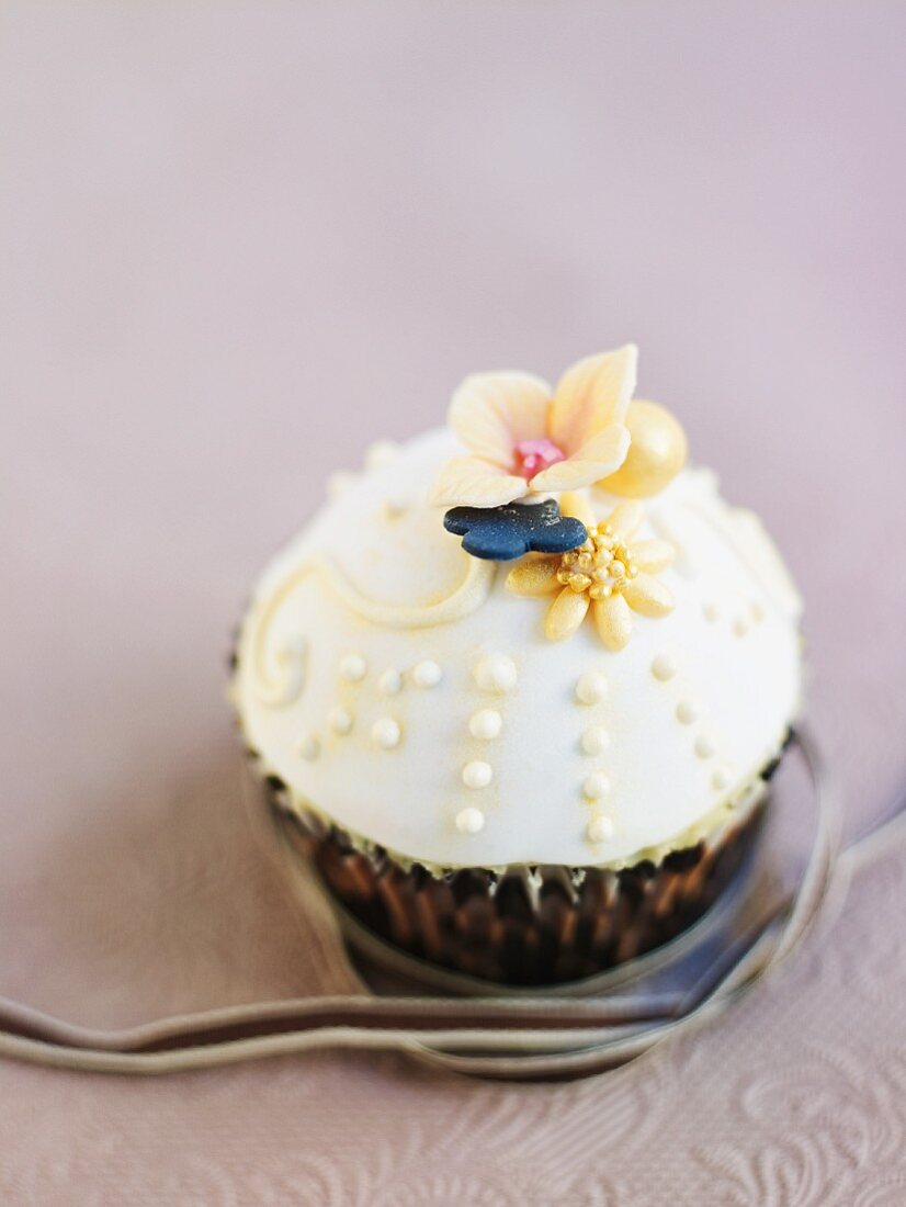 A cupcake decorated with white icing