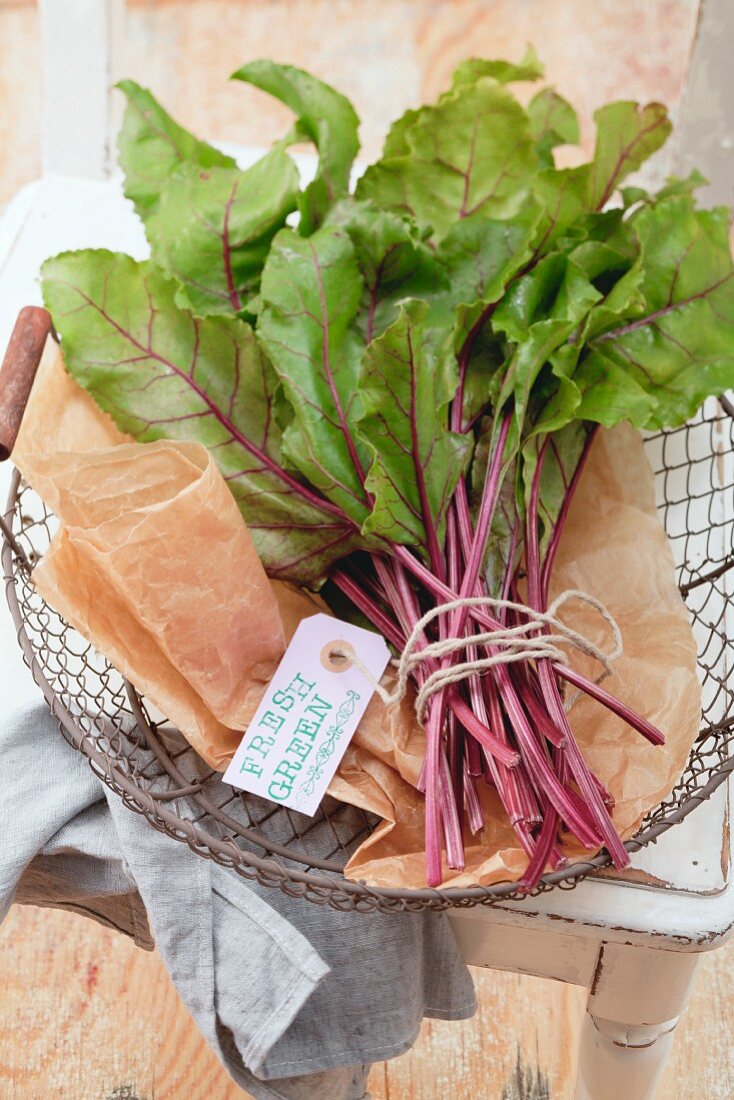 Fresh beetroot leaves in a wire basket