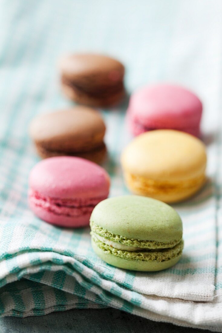 Coloured macaroons on a tea towel