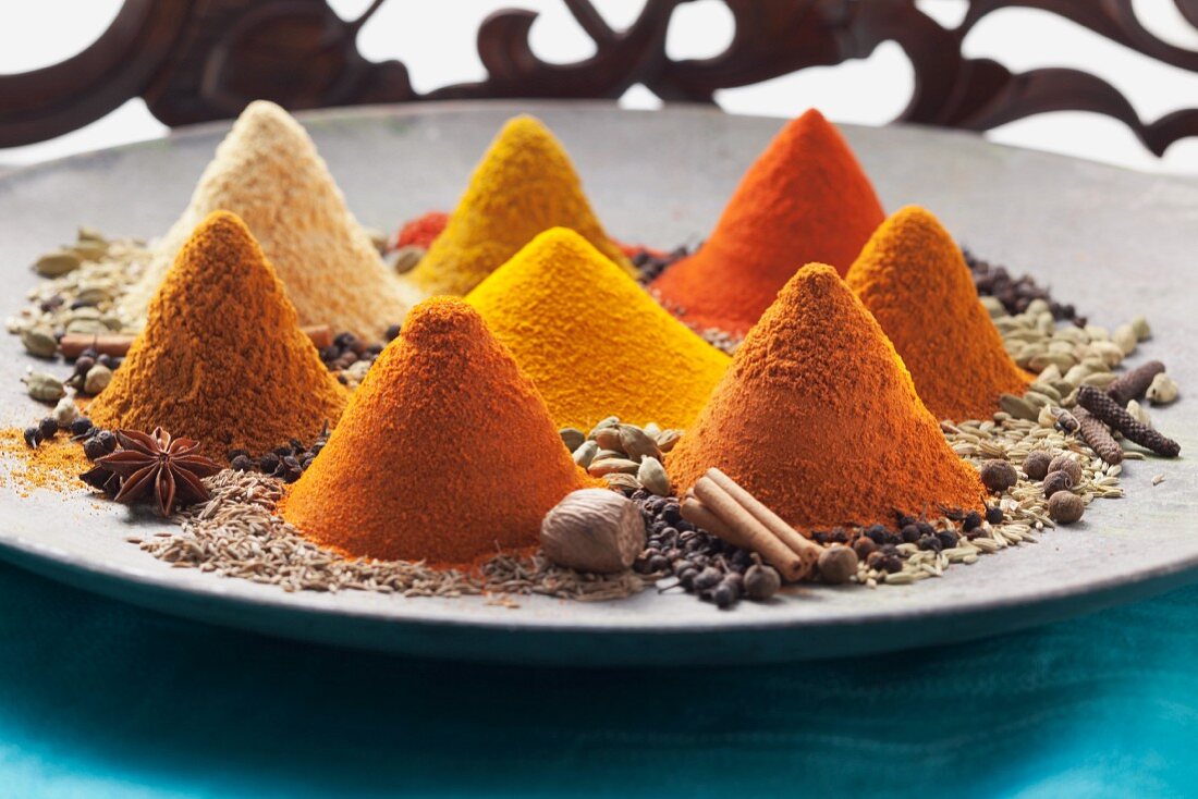 An arrangement of piles of spices on a plate