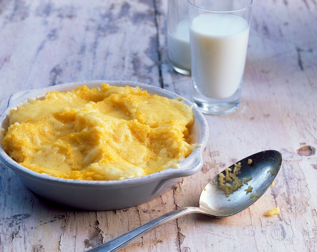 Corn mush with cheese and glasses of milk