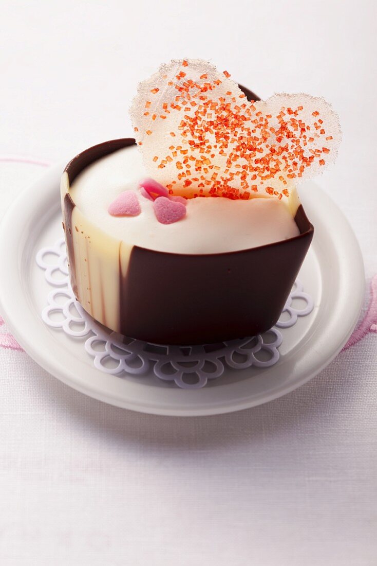 A heart-shaped praline decorated with a sugar heart