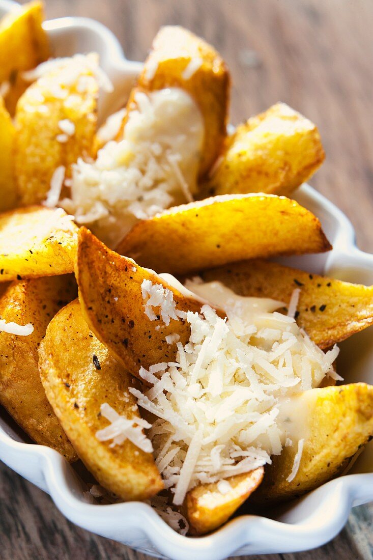 Potato wedges with mayonnaise and Parmesan