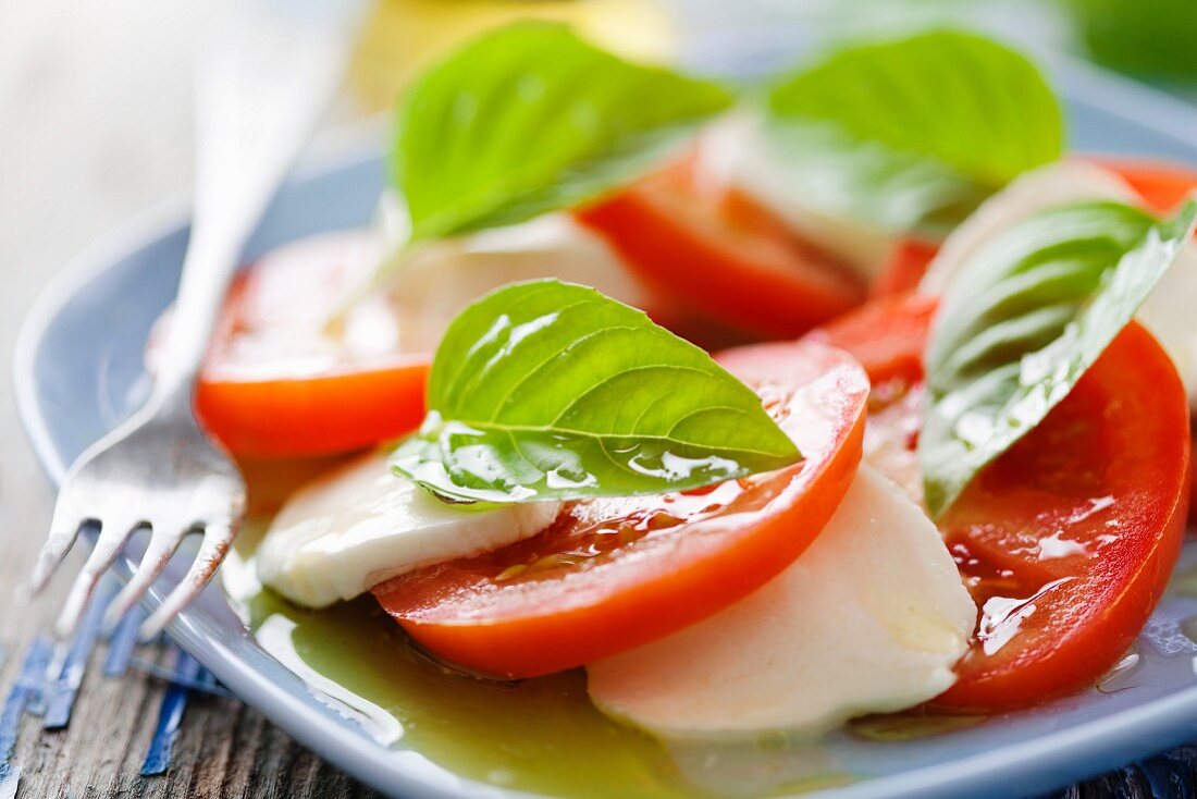 Insalat caprese (tomatoes with mozzarella, basil and olive oil)