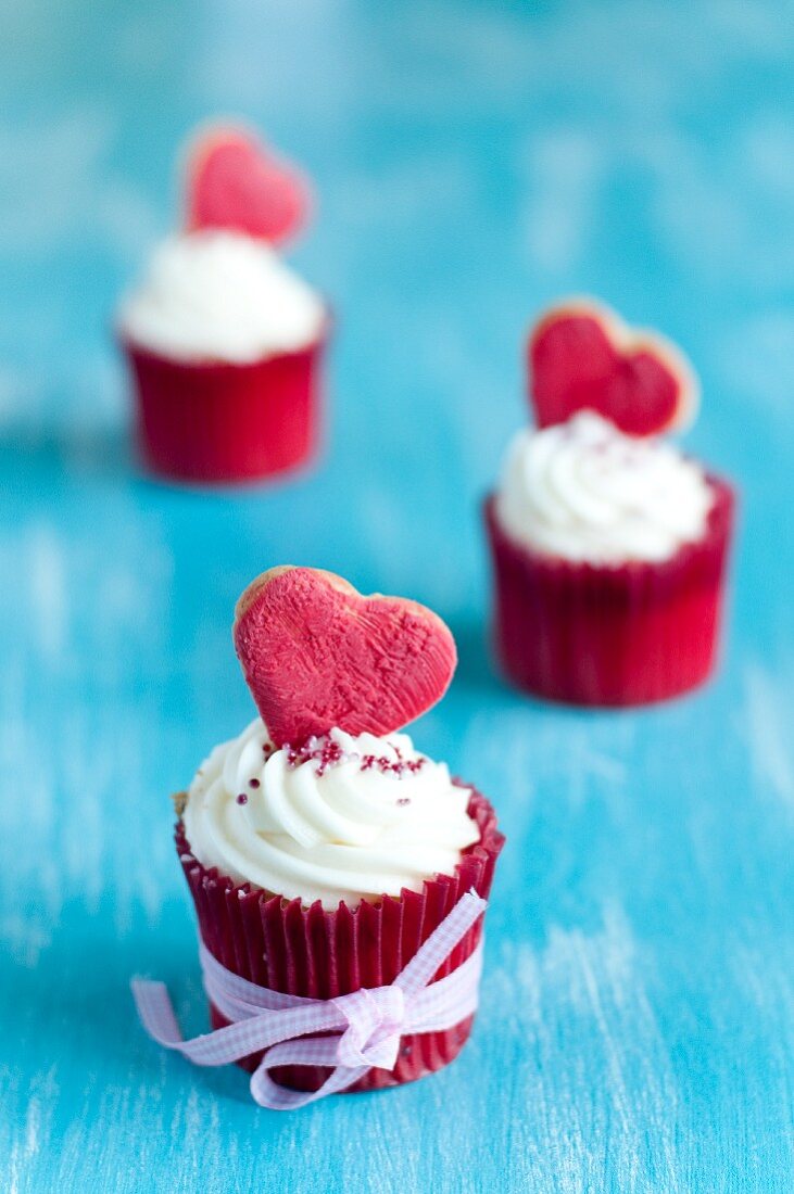 Mini vanilla cupcakes decorated with heart-shaped biscuits