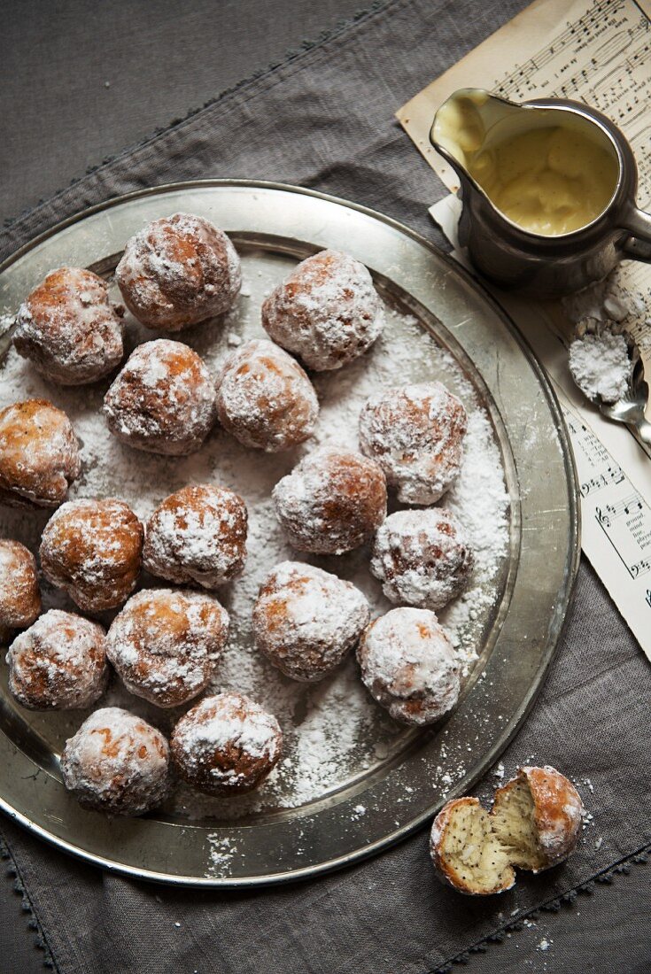Fried poppy seed balls dusted with icing sugar