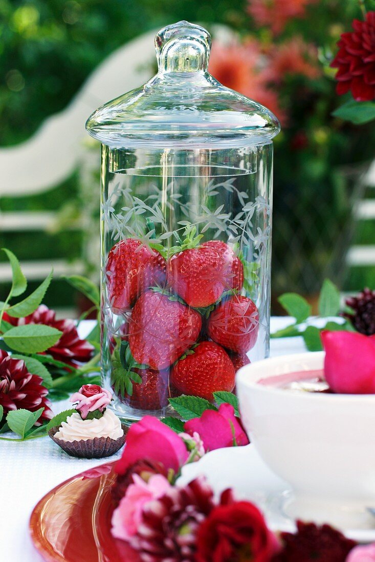 Fresh strawberries in a tall jar