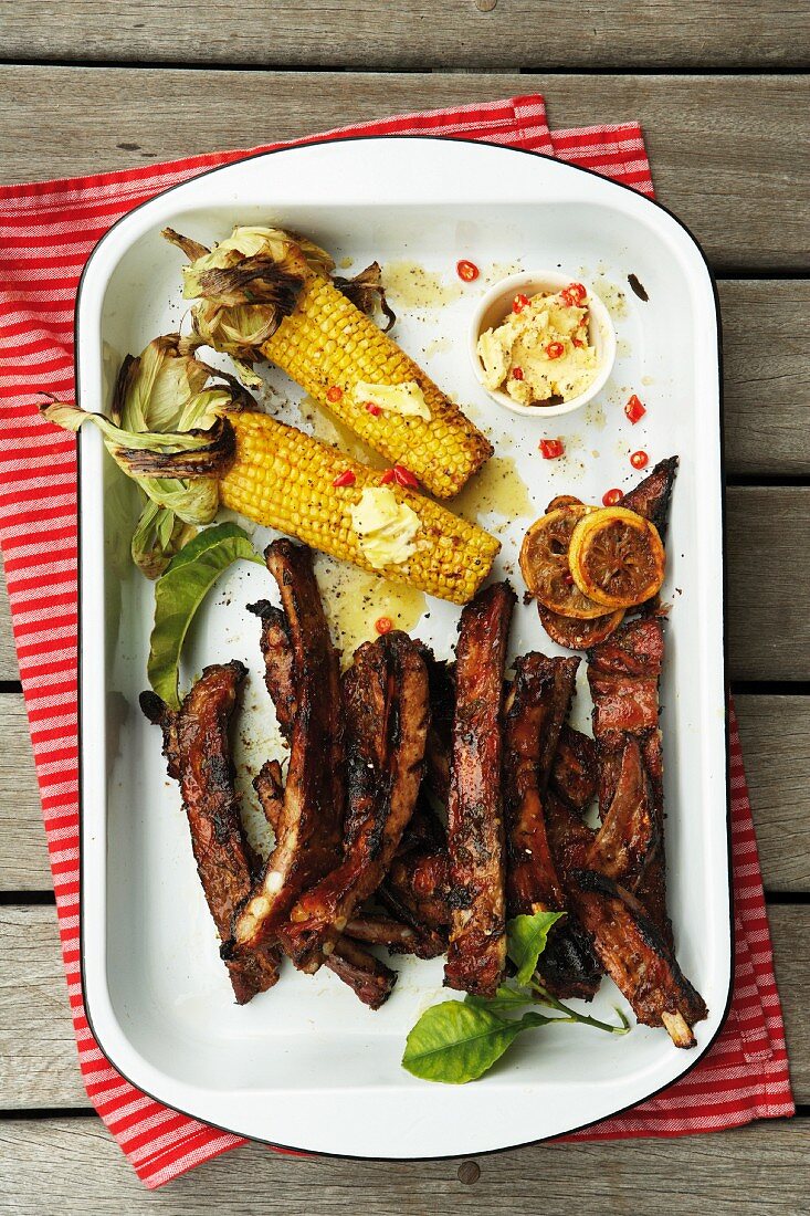 Barbecued, marinated pork ribs (honey & soy marinade) with corn cobs
