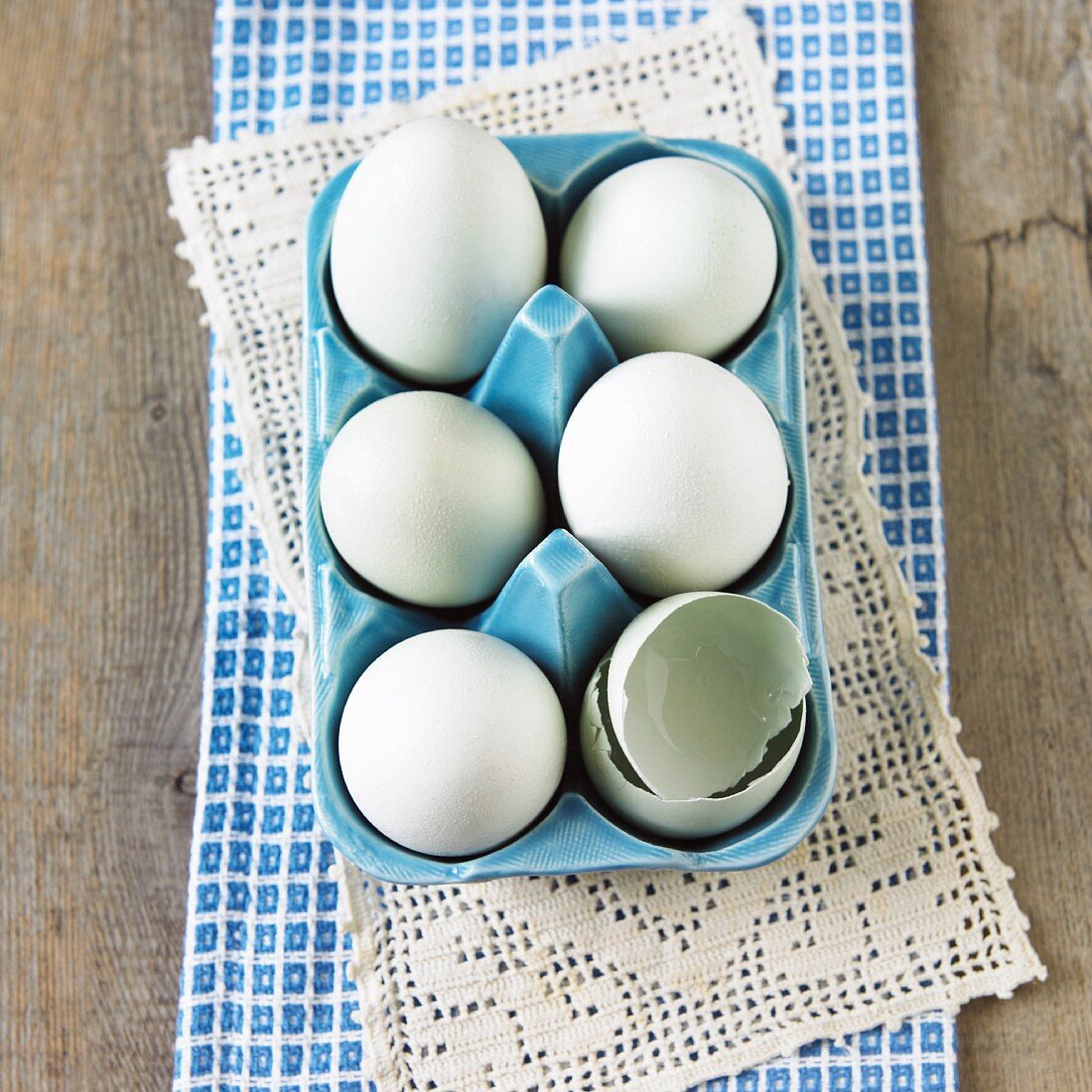 Six American Hen Eggs in an Egg Carton; One Broken; From Above