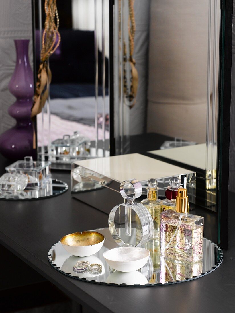 Perfume and jewellery box on dressing table in bedroom
