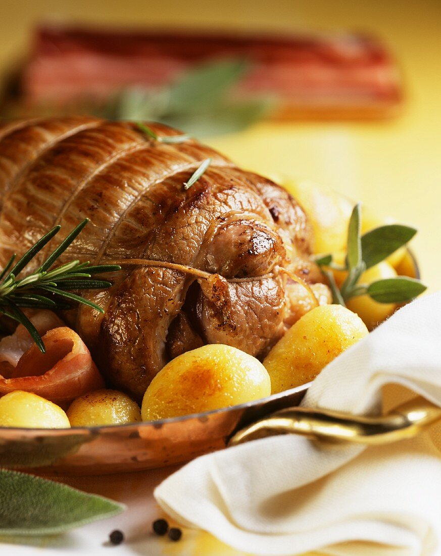 Roast veal with rosemary, sage, bacon and potatoes