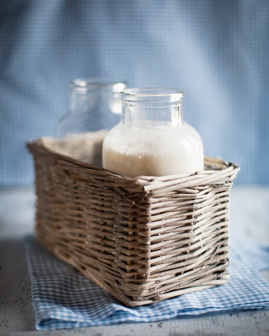 Two bottles of milk in a basket