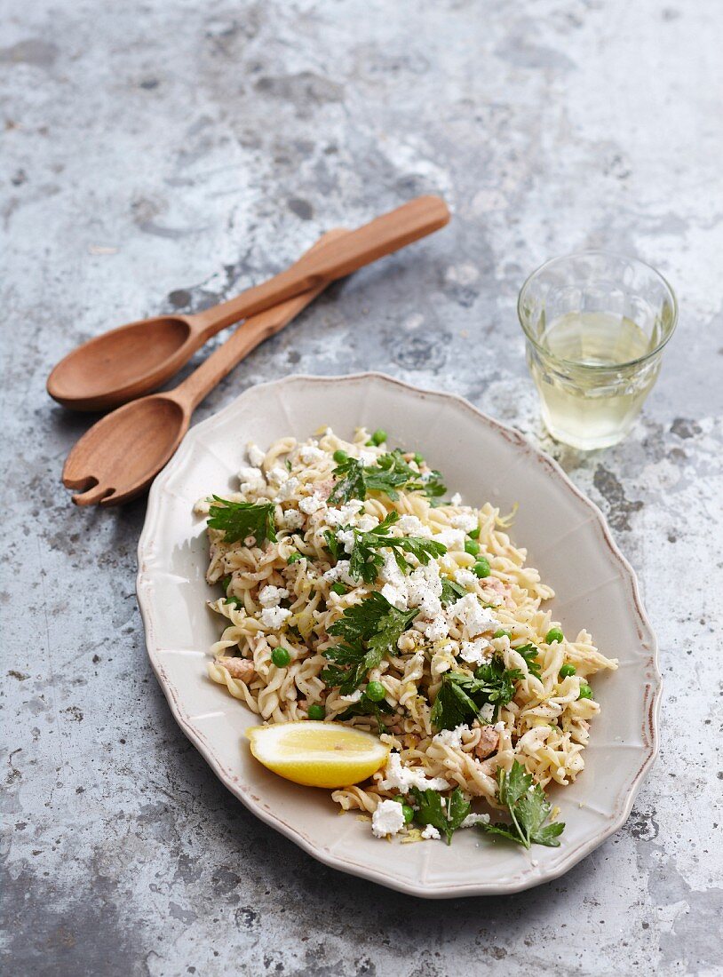 Warm pasta salad with salmon and parsley