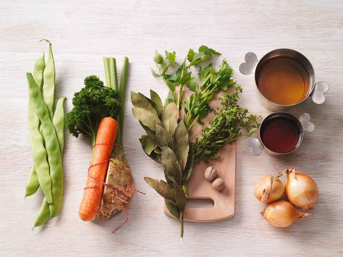 Various soup ingredients (vegetables, herbs, stock)