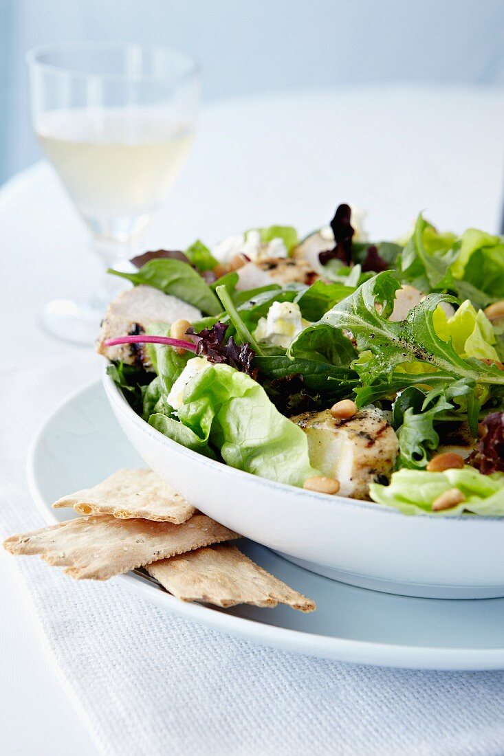 Grilled Chicken Salad with Mixed Greens, Caesar Dressing, Glass of White Wine and Crackers