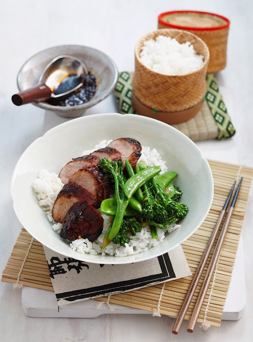 Braised, marinated pork fillet with vegetables on a bed of rice