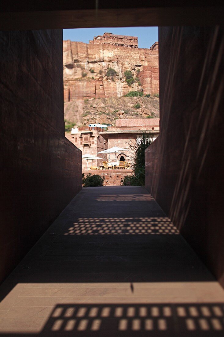 Paved corridor with view of mountain fortress in Raas Haveli Hotel, Jodhpur, India