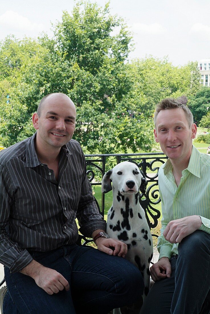 Men with dog posing on balcony