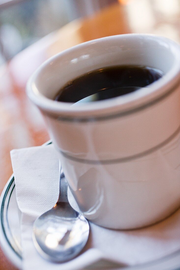 Black Coffee in a Diner Cup on a Saucer with Spoon